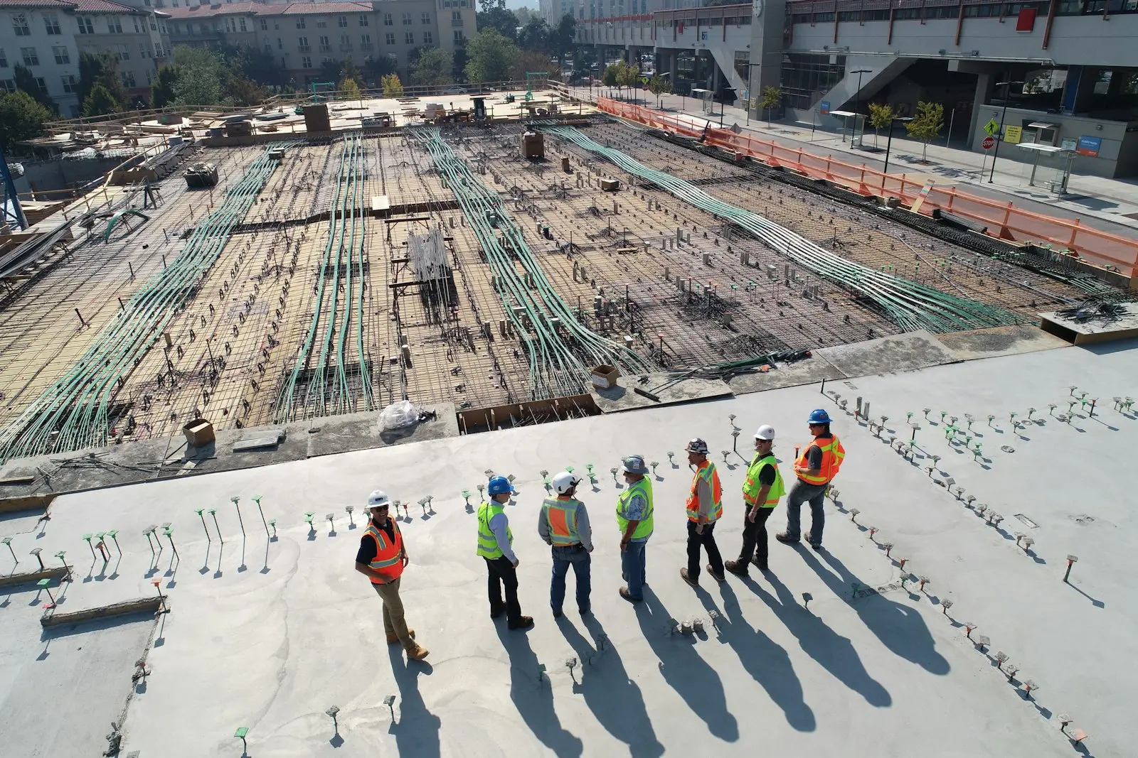 Construction site with workers on a rooftop slab