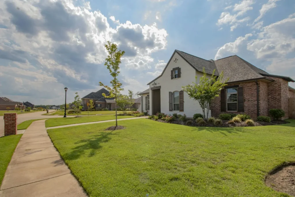 Home exterior with finished siding and landscaping